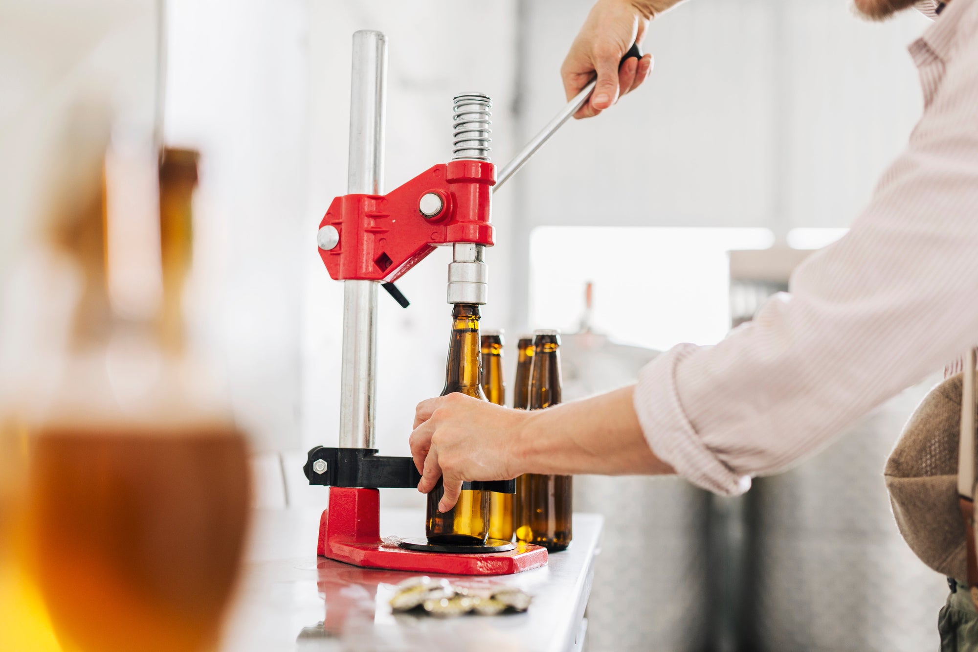 Beer Capper on a kitchen counter being used by a home brewer