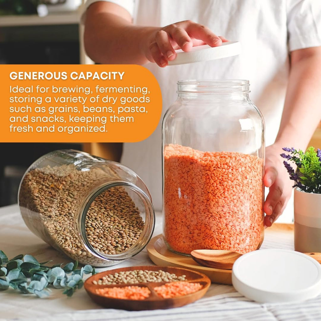 Set of four 1-gallon clear glass brewing and fermentation jars by FastRack, featuring wide mouths and airtight lids.