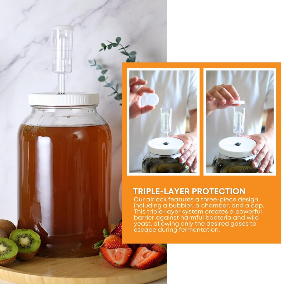 Three FastRack fermentation airlocks used for home brewing, made of clear plastic with rubber seals for airtight fermentation.