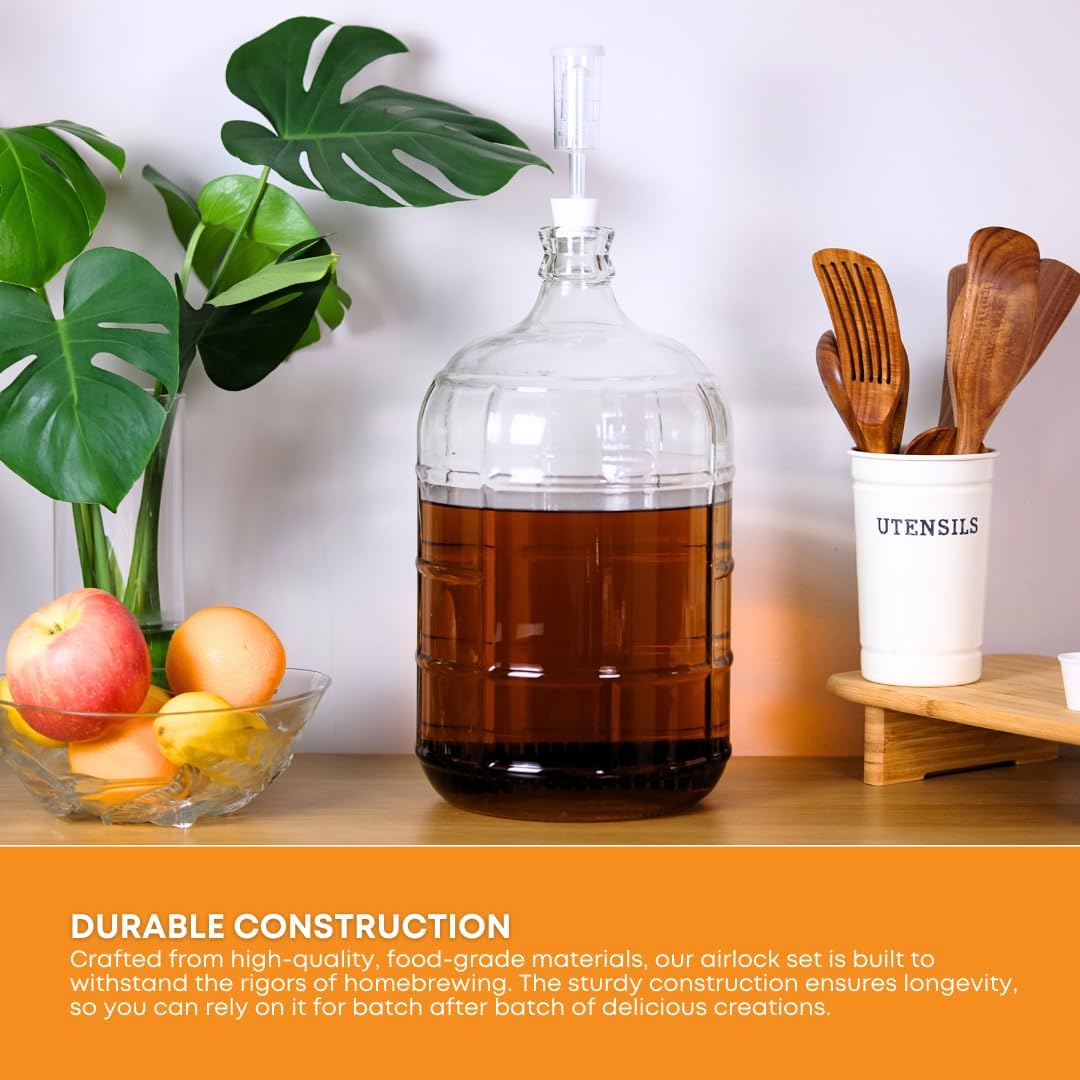 Three FastRack fermentation airlocks for home brewing, showing clear plastic S-shaped design with rubber grommets.